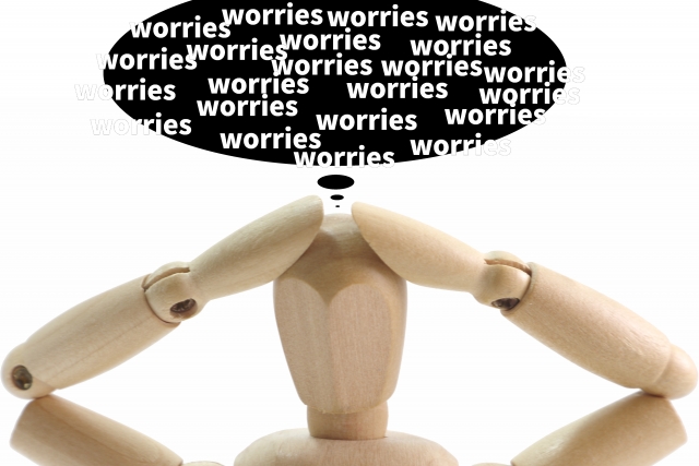 wooden-drawing-mannequin-holding-its-head-in-frustration-with-a-thought-bubble-filled-with-the-word-worries-representing-english-learning-struggles